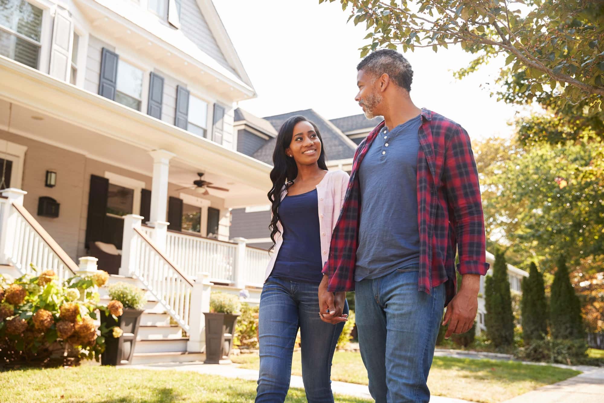 smiling couple outside home